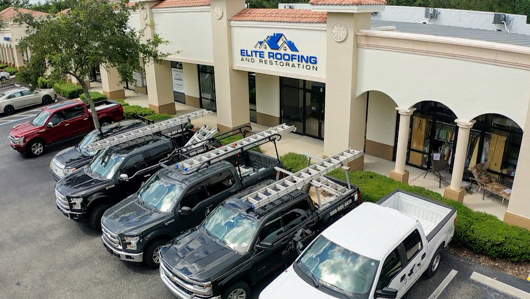 Elite Roofing crew working on a SW Florida roof under blue skies